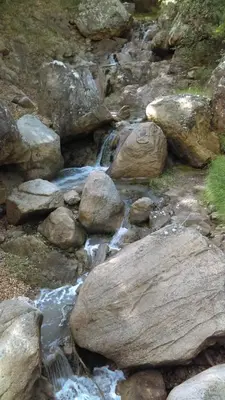 a stream of water with rocks on a mountain at Le Chateau in Camps-sur-lʼAgly