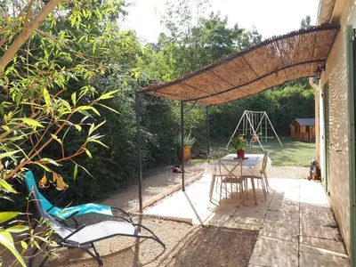 a patio with a table and chairs under a pergola at Sirius in Fa