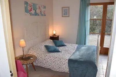 a bedroom with a bed with blue pillows on it at Sirius in Fa
