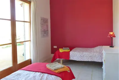 a room with two beds and a red wall at Sirius in Fa