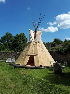 a teepee tent sitting in a field of grass at Sirius in Fa