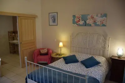 a bedroom with a bed with blue pillows at Sirius in Fa