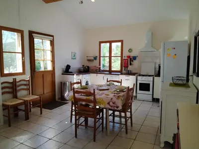 a kitchen with a table and chairs and a refrigerator at Sirius in Fa