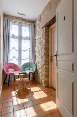 a room with a table and chairs and a window at Abitarela - Maison d'Hôtes - B&B in Sigean