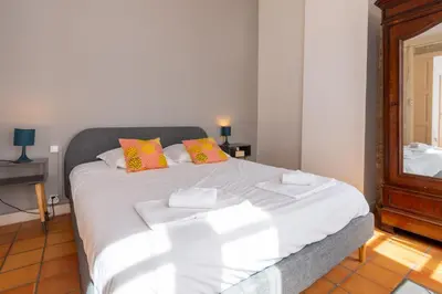 a bedroom with a large white bed with two pillows at Abitarela - Maison d'Hôtes - B&B in Sigean