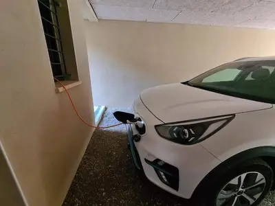 a white car is hooked up to a wall at LE COSY GITE in Duilhac