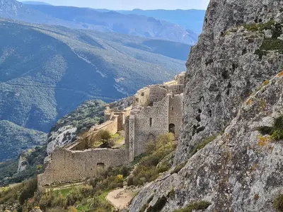a castle on the side of a mountain at LE COSY GITE in Duilhac