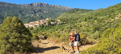 a man and a woman standing on a mountain trail at LE COSY GITE in Duilhac