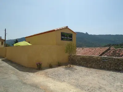 a building with a sign on the side of it at Chambre d'hôte in Cucugnan