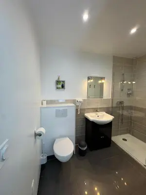 a bathroom with a toilet and a sink and a shower at Chambre d'hôte in Cucugnan