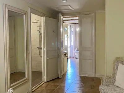 a bathroom with a walk in shower and a mirror at Sainte-Hélène Chambres d'Hôtes & Appartement in Olonzac