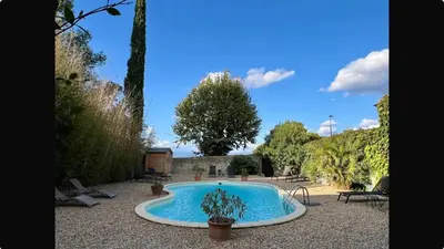 a swimming pool in the middle of a yard at Aux Anges Gardiens in Carcassonne
