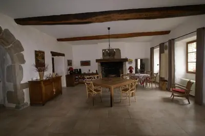 a living room with a blue couch and a table at Abbaye de Capservy in Villardonnel