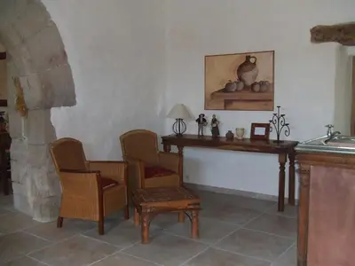 a living room with a table and chairs and a table and chairs at Abbaye de Capservy in Villardonnel