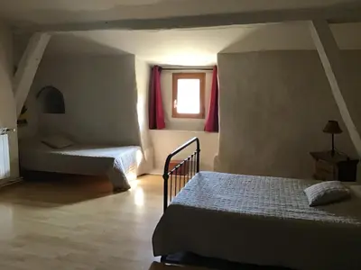 a bedroom with a bed and a living room at Abbaye de Capservy in Villardonnel