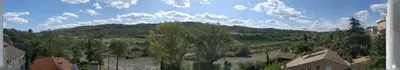 a view of a small town with a mountain at LA MAISON MIRAVA in La Caunette