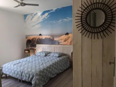 a bedroom with a bed and a mural of animals at LA MAISON MIRAVA in La Caunette