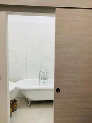 a bathroom with a white tub and a sink at LE 31 in Carcassonne
