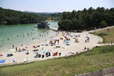 a group of people on a beach in the water at LE 31 in Carcassonne