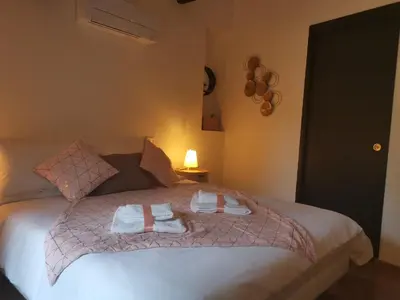a bedroom with a bed with towels on it at La Maison Cachée in Carcassonne