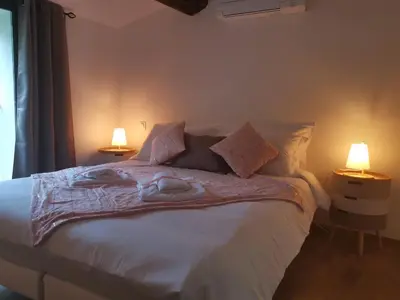 a bedroom with a bed with two lamps on it at La Maison Cachée in Carcassonne