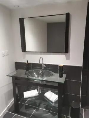 a bathroom with a sink and a mirror at La Maison Cachée in Carcassonne