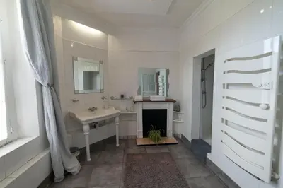 a white bathroom with a sink and a fireplace at Appartement de 2 Chambres au 1er Etage in Carcassonne