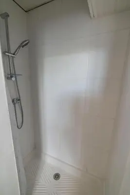 a bathroom with a shower with white tiles at Appartement de 2 Chambres au 1er Etage in Carcassonne