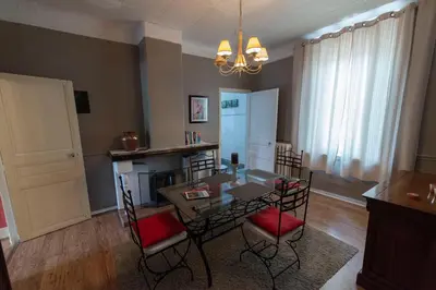 a living room with a table and chairs and a fireplace at Appartement de 2 Chambres au 1er Etage in Carcassonne