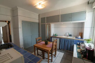 a small kitchen with a wooden table and a dining room at Appartement de 2 Chambres au 1er Etage in Carcassonne