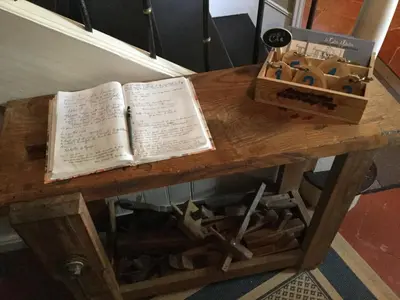 a wooden table with an open book and a box at Le Clos d'André in Castelnaudary