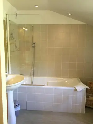 a bathroom with a bath tub and a sink at Le Clos d'André in Castelnaudary