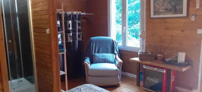 a room with a chair and a book shelf at Chambre La Caunette in La Caunette