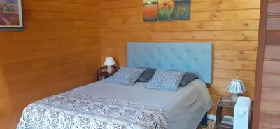 a bedroom with a bed with a blue head board at Chambre La Caunette in La Caunette
