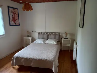 a bedroom with a bed and two night stands at Vue sur L'Ourtizet in Rodome