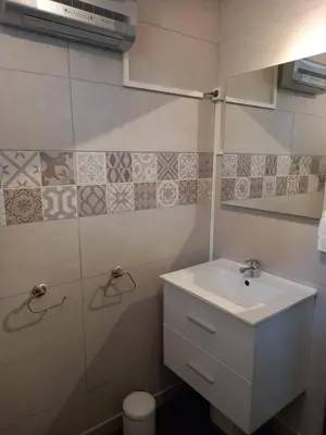 a bathroom with a sink and a mirror at Vue sur L'Ourtizet in Rodome