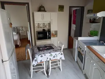 a small kitchen with a table and chairs in it at Vue sur L'Ourtizet in Rodome