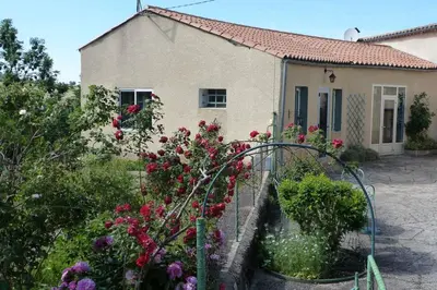 a garden with flowers in front of a house at Vue sur L'Ourtizet in Rodome