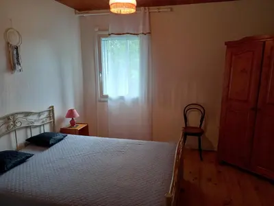 a bedroom with a large bed and a window at Vue sur L'Ourtizet in Rodome