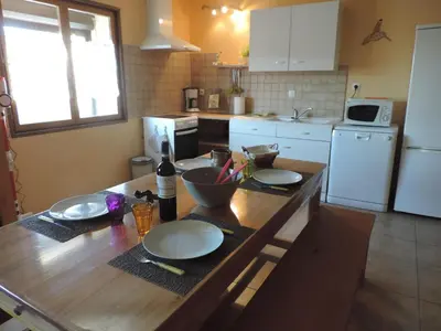 a kitchen with a wooden table with plates on it at Gîtes Le 