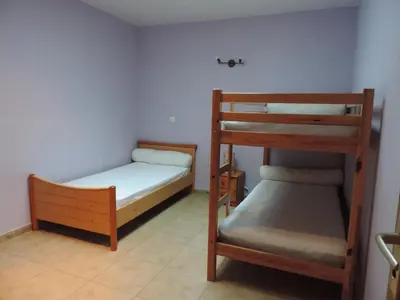 a bedroom with two bunk beds and a ladder at Gîtes Le 