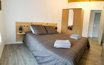 a bedroom with a bed with two towels on it at La Limonadière in Port-la-Nouvelle