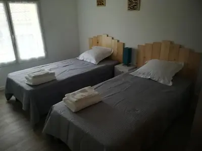 two beds sitting next to each other in a room at La Limonadière in Port-la-Nouvelle