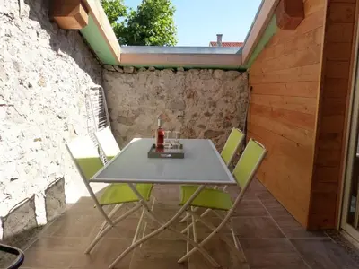 a table and chairs on the patio of a house at La Limonadière in Port-la-Nouvelle