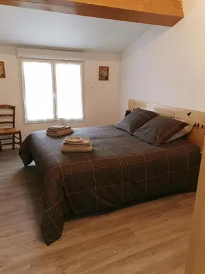a bedroom with a bed with two towels on it at La Limonadière in Port-la-Nouvelle