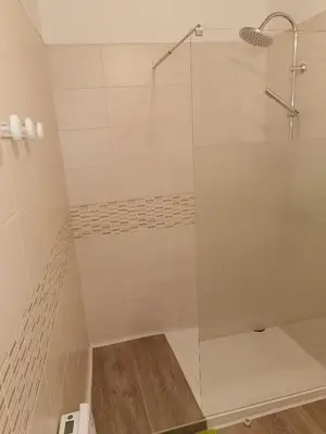 a shower with a glass door in a bathroom at La Limonadière in Port-la-Nouvelle