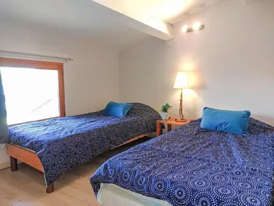a bedroom with two beds and a window at Holiday Home La Maison de l'Etang by Interhome in Gruissan