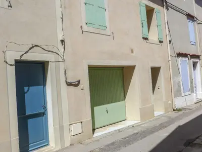 two entrances to a building with green and blue doors at Holiday Home La Maison de l'Etang by Interhome in Gruissan