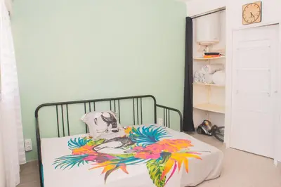 a bedroom with a bed with a painting on it at le studio du Grazel in Gruissan