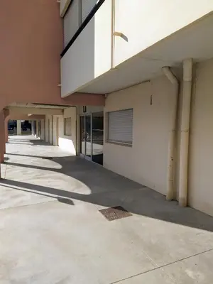 an empty hallway of a building with columns at le studio du Grazel in Gruissan